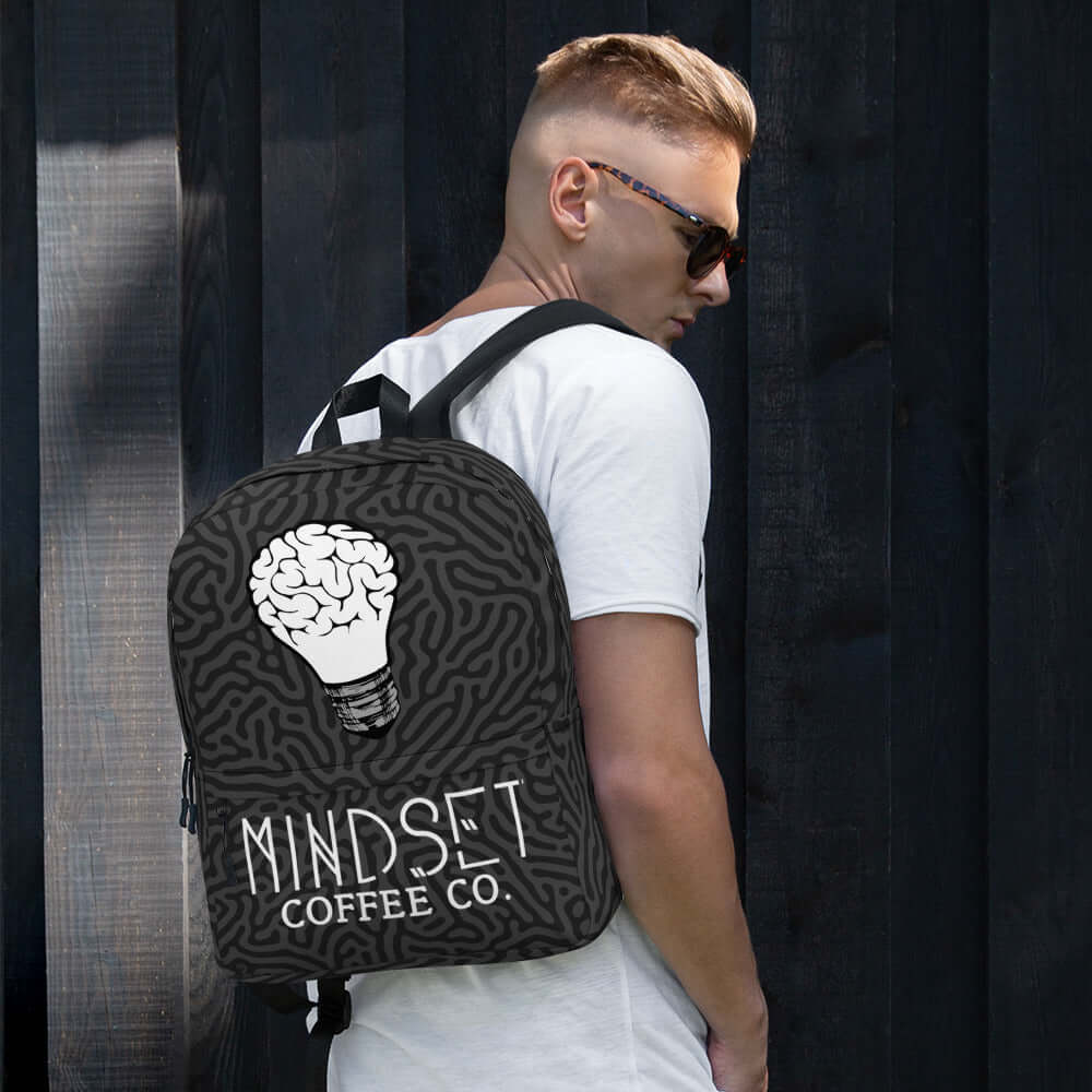 Mindset Coffee Backpack on a person, showcasing a stylish design with a brain-inspired graphic.