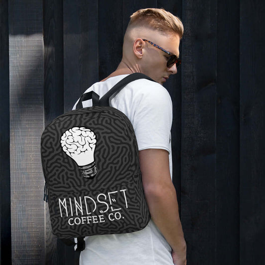 Mindset Coffee Backpack on a person, showcasing a stylish design with a brain-inspired graphic.