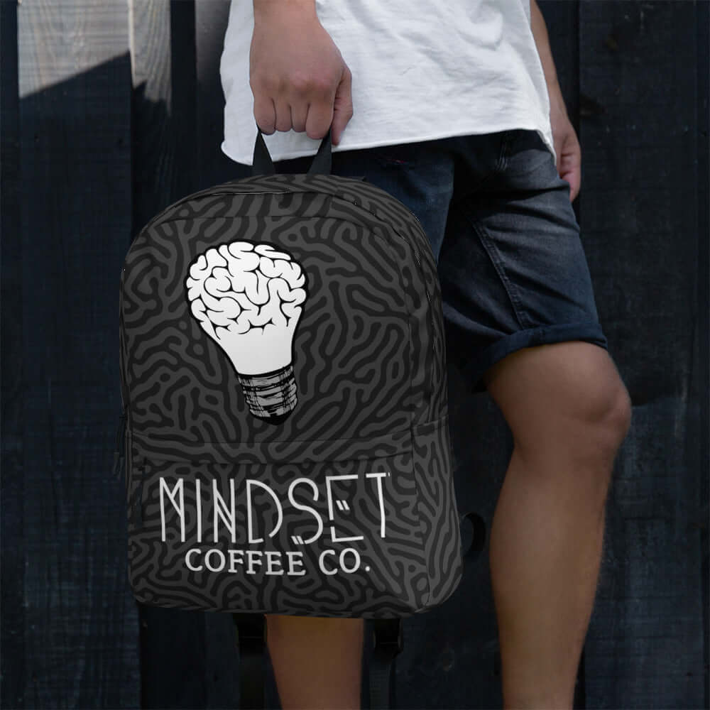 Mindset Coffee Backpack featuring a unique design with a lightbulb graphic and stylish look, perfect for everyday use.