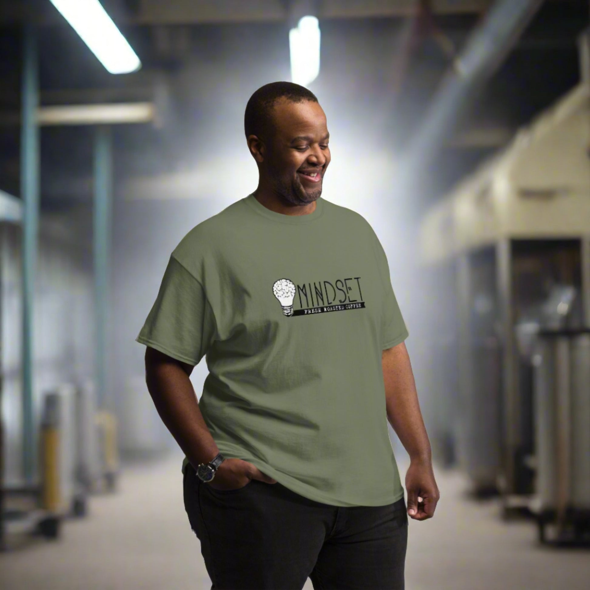 man wearing green mindset coffee shirt